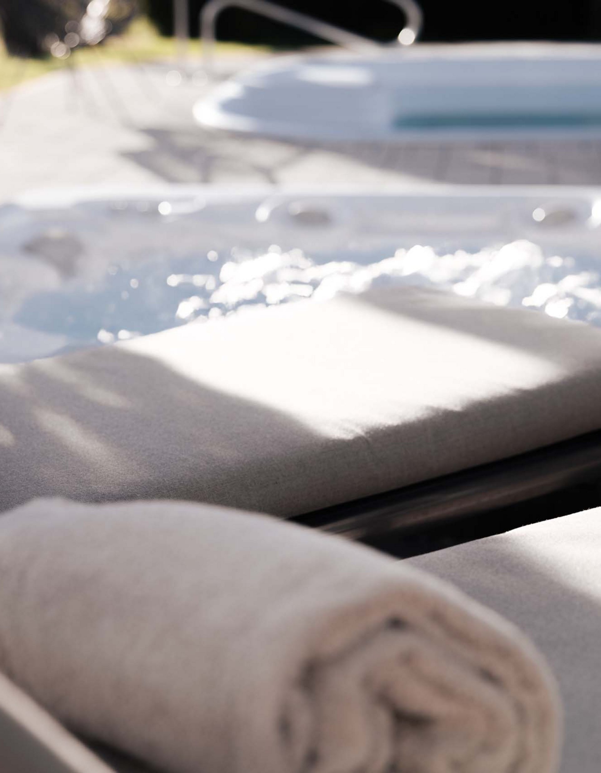 Lingers’ best snapshots Two towels on loungers beside an outdoor bubbling hot tub