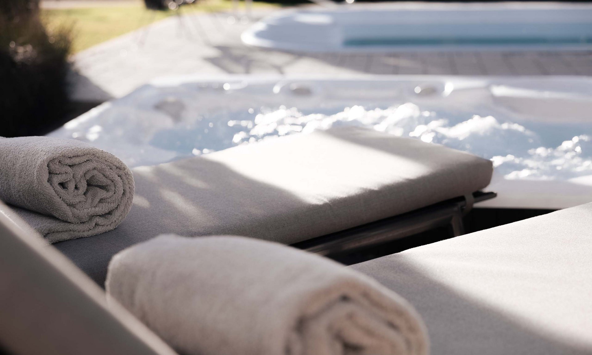Lingers’ best snapshots Two towels on loungers beside an outdoor bubbling hot tub