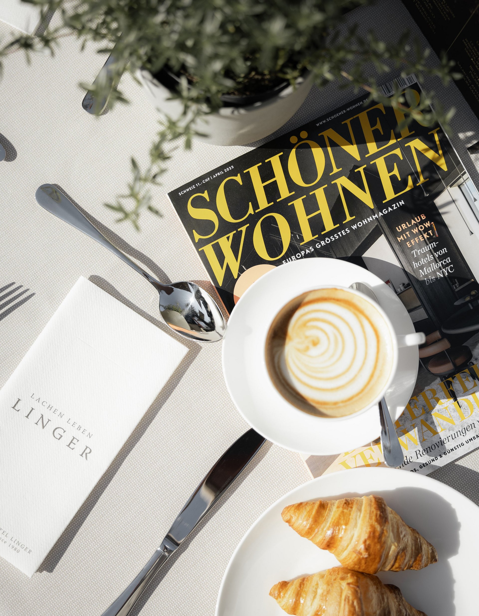 Lingers’ best snapshots Breakfast with cappuccino, croissants and magazine on white table