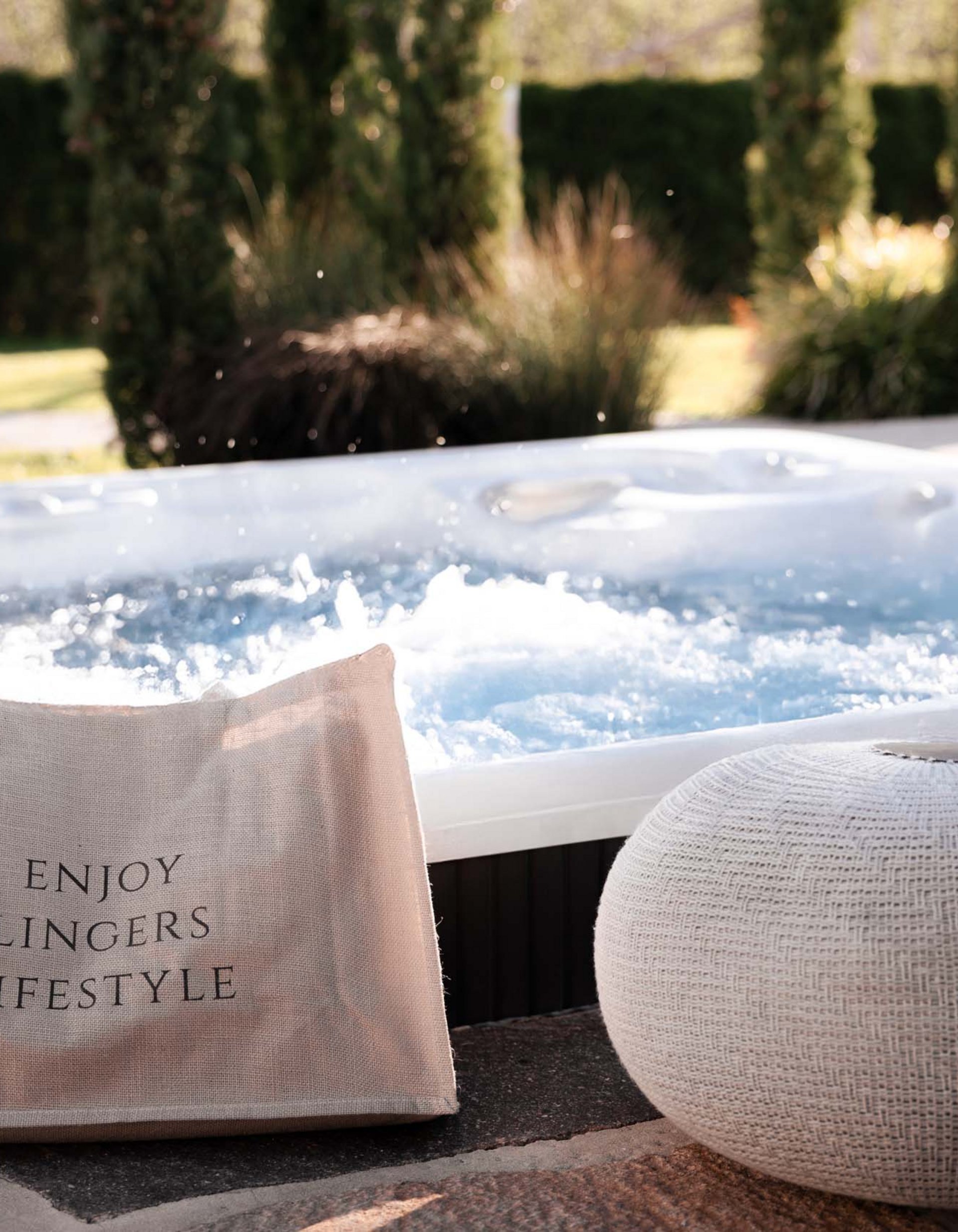Lingers’ best snapshots Hot tub in garden with bag and white woven seat cushion
