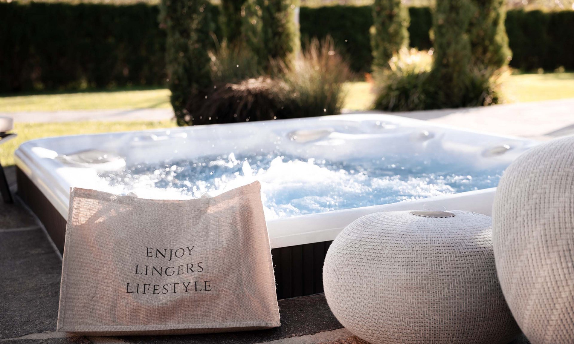 Lingers’ best snapshots Hot tub in garden with bag and white woven seat cushion