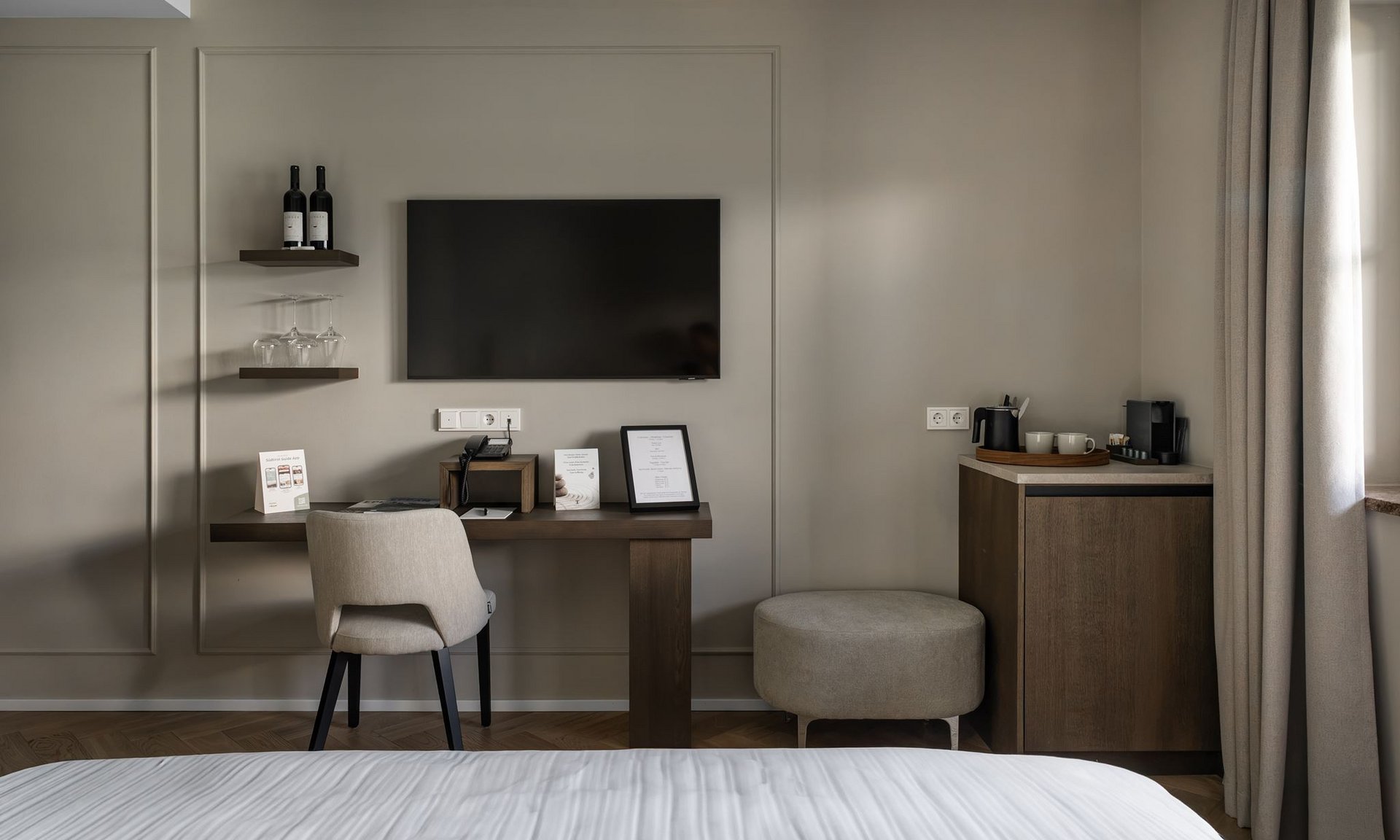 Lingers’ best snapshots Modern hotel room workspace with TV, chair, and coffee setup