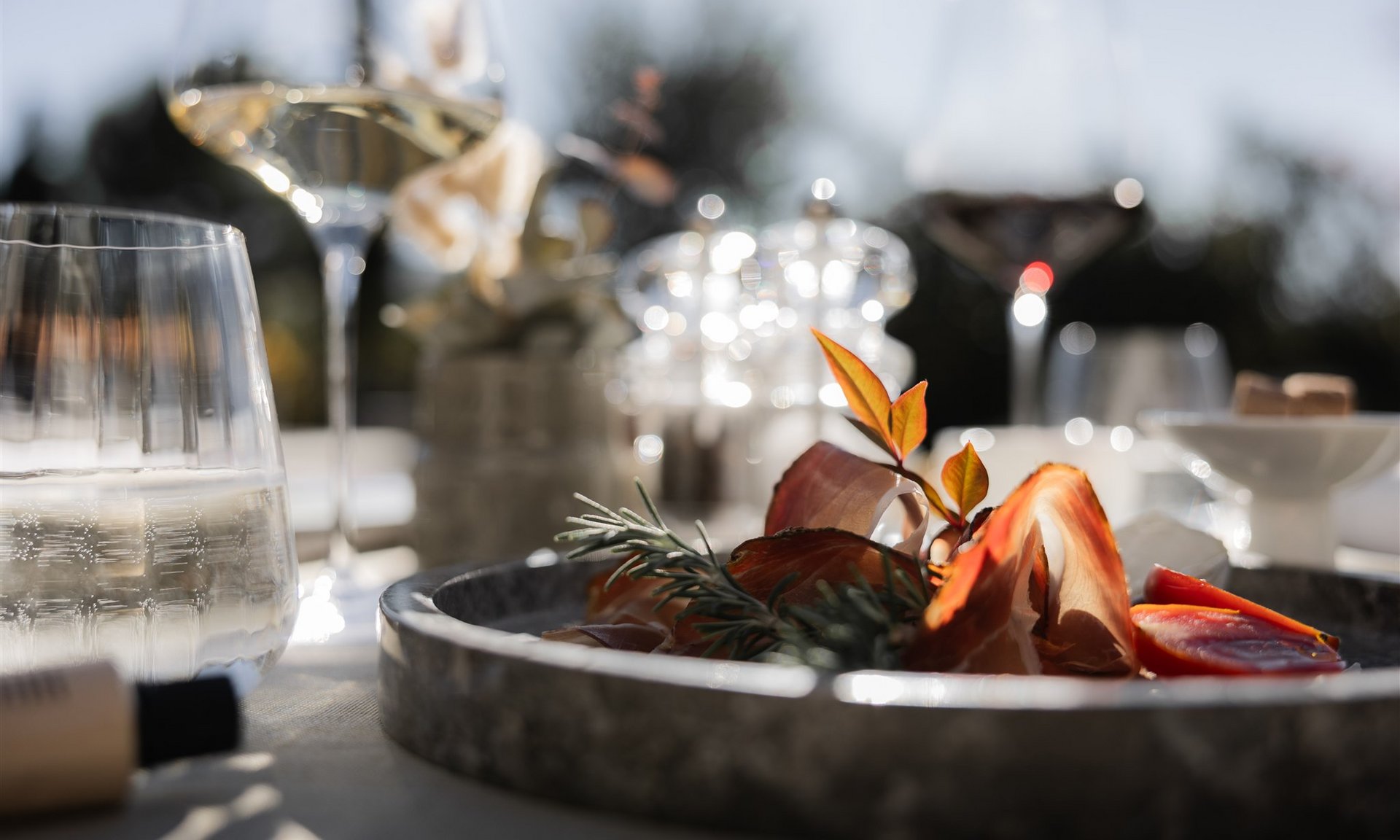 Lingers’ best snapshots Antipasti plate with ham, tomatoes, and herbs in sunlight