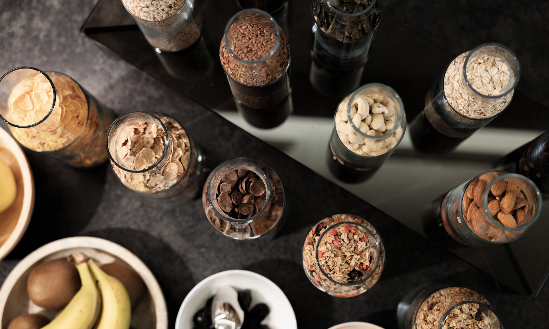 Lingers’ best snapshots Various nuts, seeds and cereals in jars and bowls on black surface