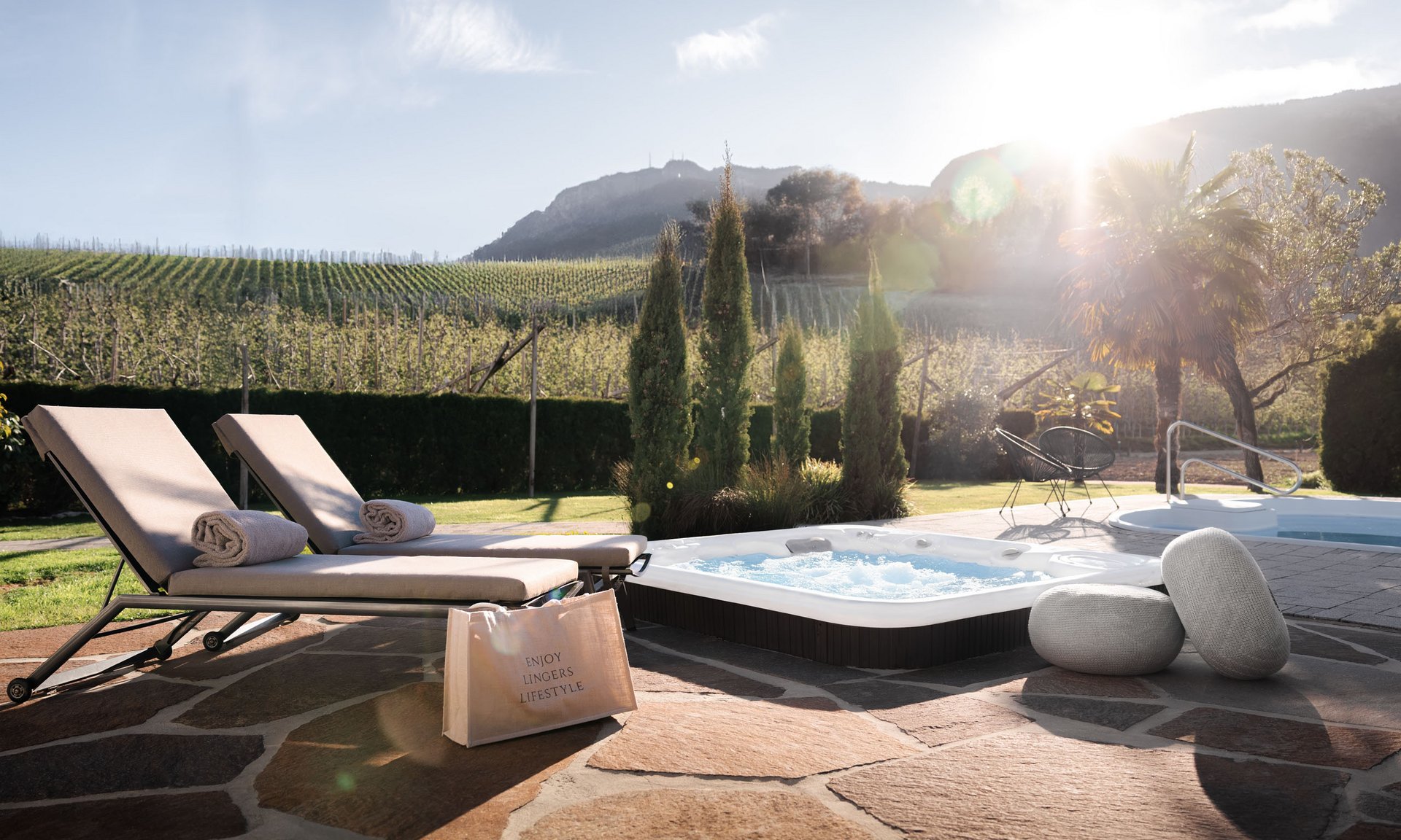 Lingers’ best snapshots Sunset by hot tub with lounge chairs and vineyard in the background