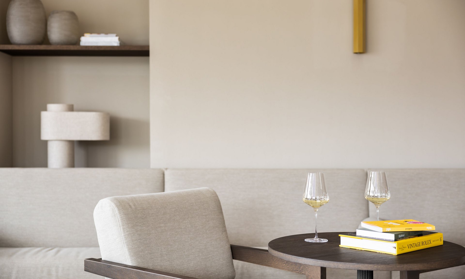 Lingers’ best snapshots Cozy seating area with armchair, table, books, and two wine glasses