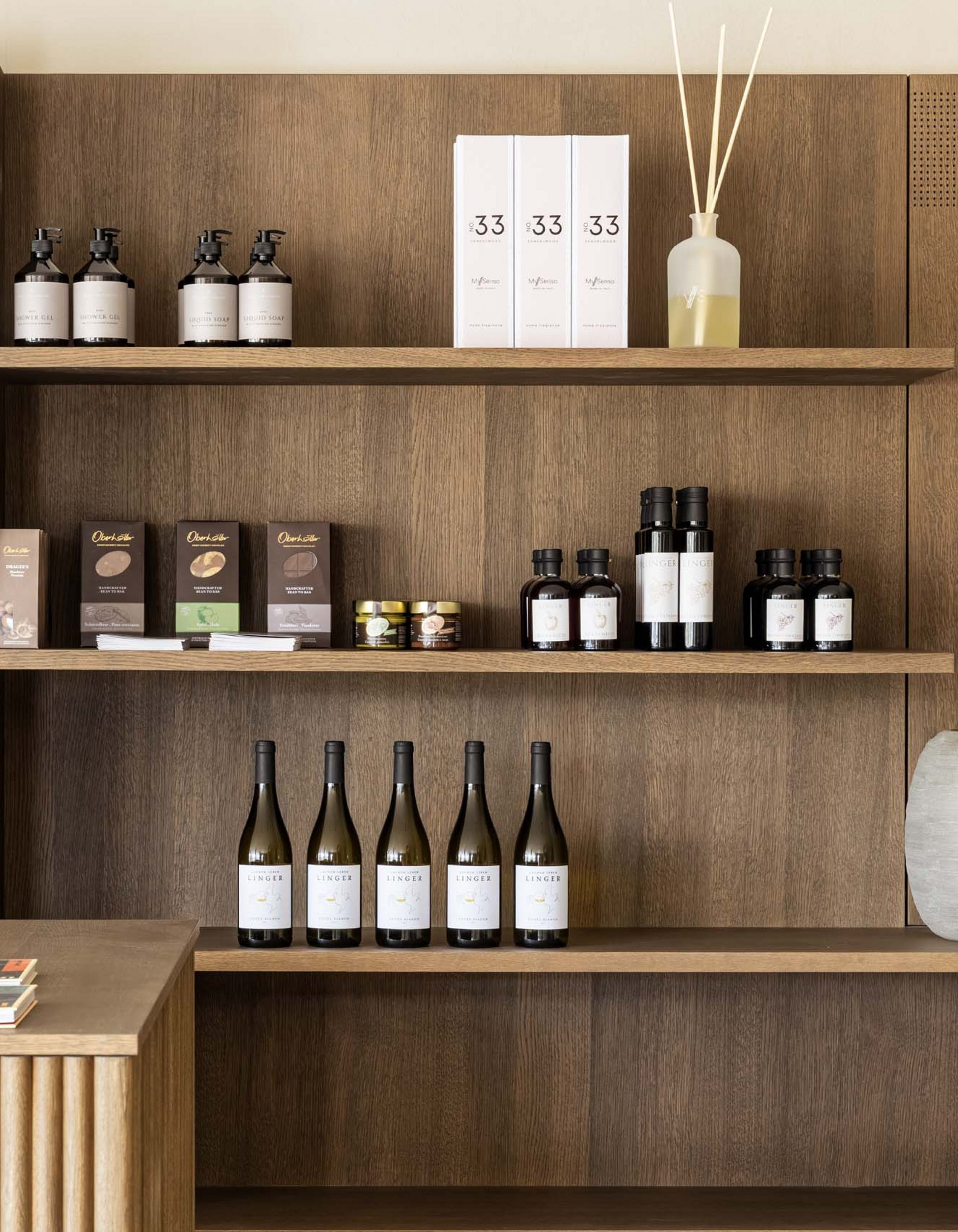 Lingers’ best snapshots Wooden shelves with books, drinks, cosmetic products, and vases